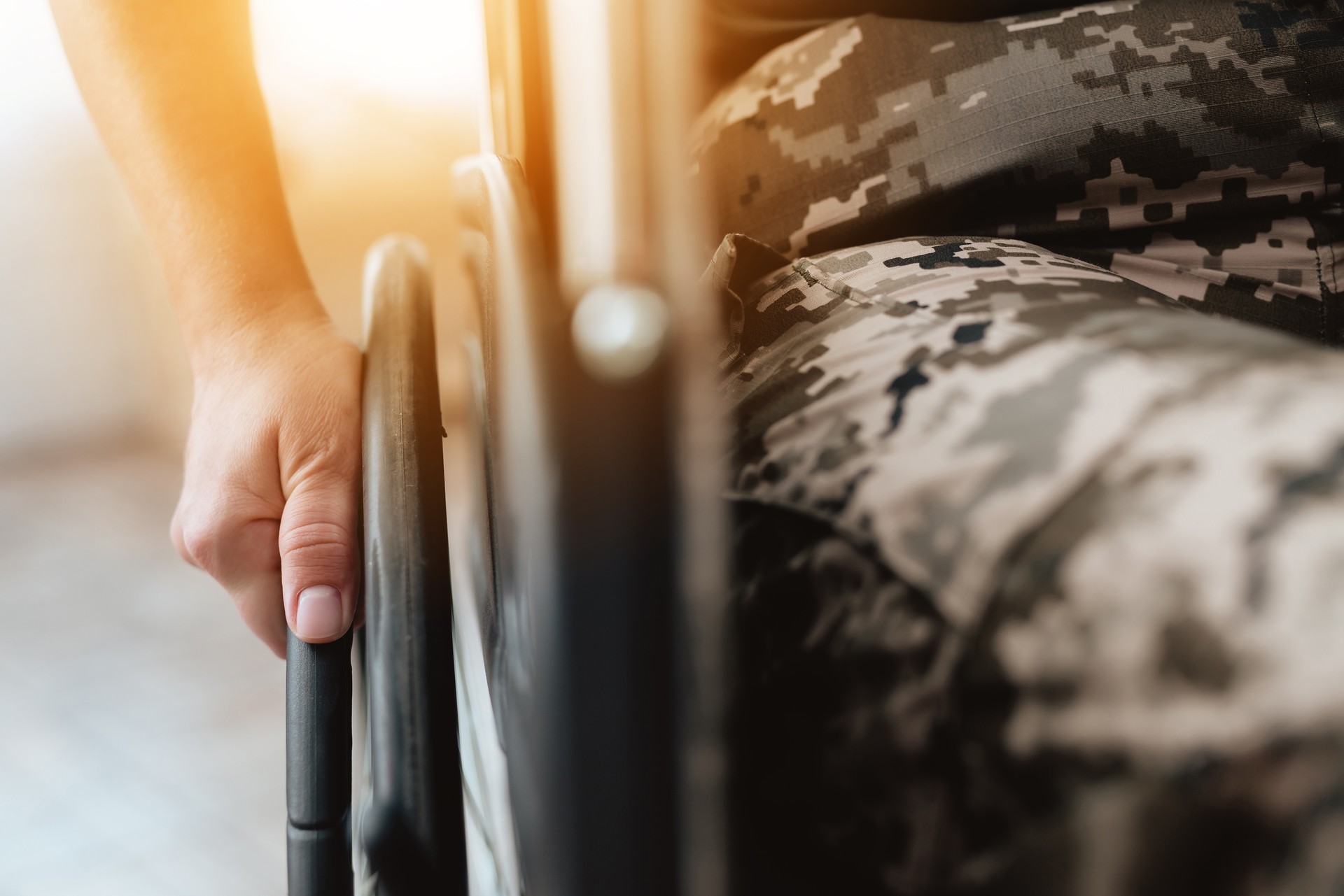 Woman veteran in wheelchair returned from army. Close-up photo veteran woman in a wheelchair.