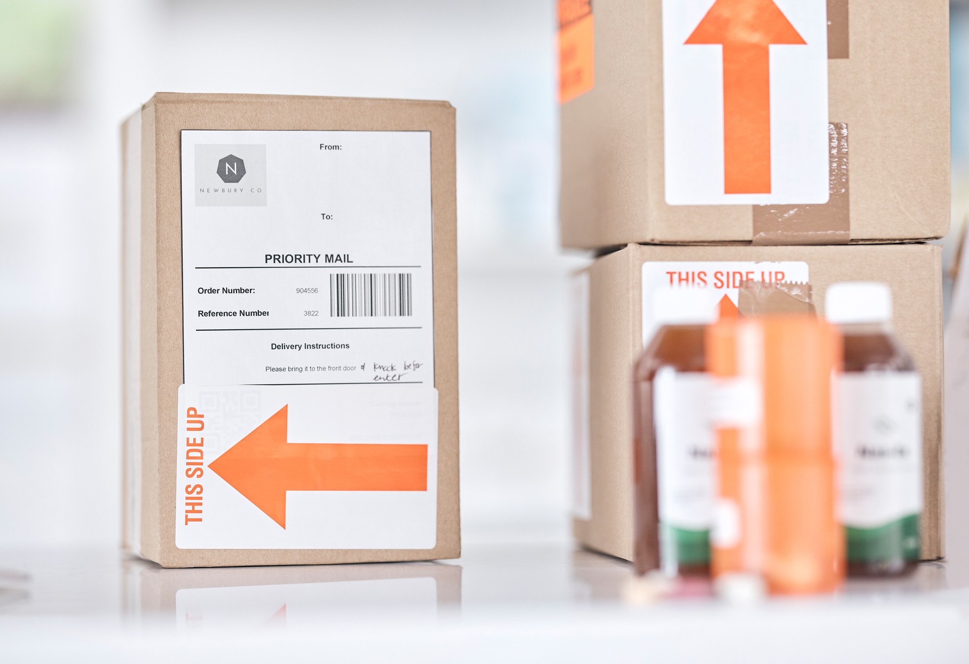 Boxes, medicine and delivery package in pharmacy for ecommerce, supply chain and healthcare on blurred background. Stock, logistics and medical product or drug distribution for health and wellness